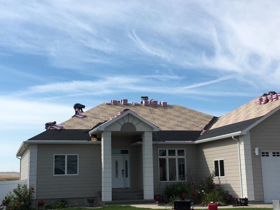 Grey house in progress of roof repair