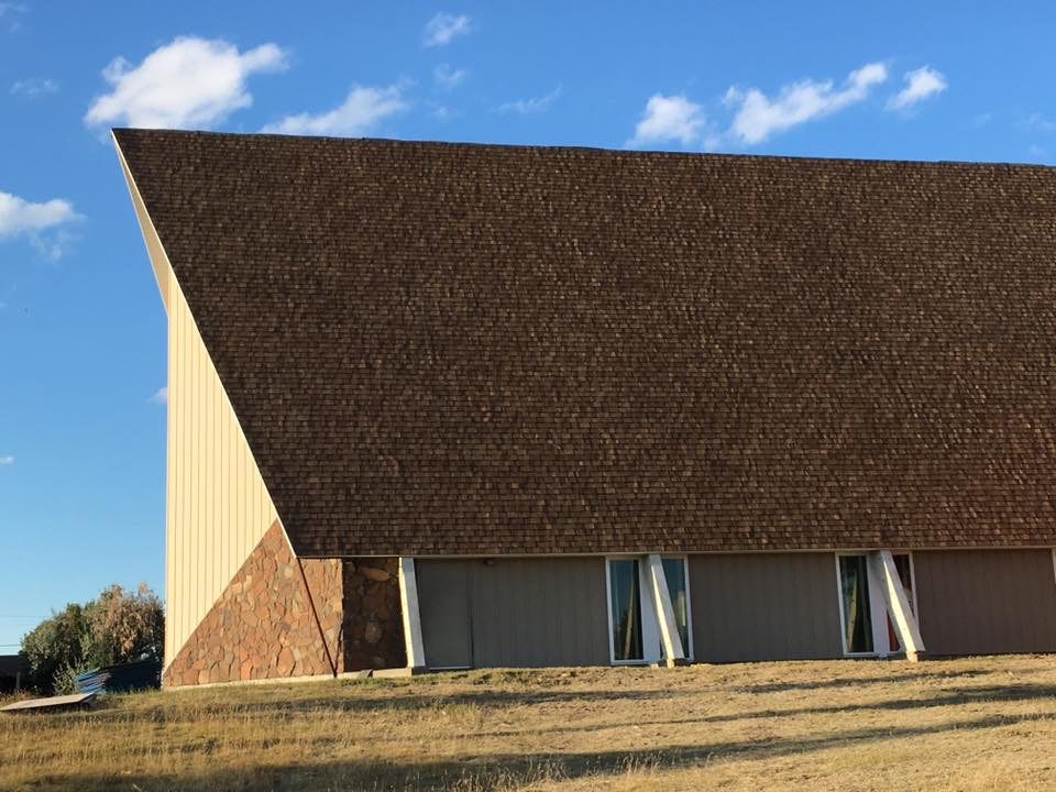 Roofing work being completed on a church.
